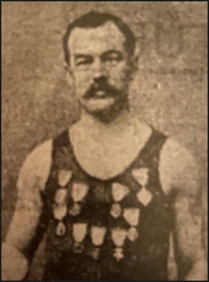Cornelius Beal showing off his medals (c. 1900)