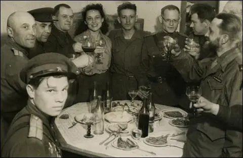Ann Stringer in mid-toast with Russian troops (1945)