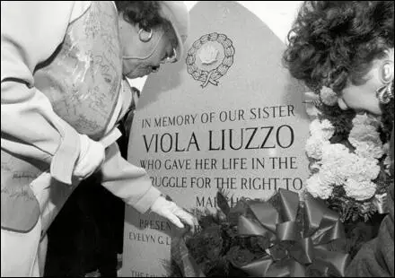 Marie Foster, left, and Evelyn Lowery, right, place a wreath at the site where civil rights activist Viola Liuzzo was killed by Ku Klux Klansmen