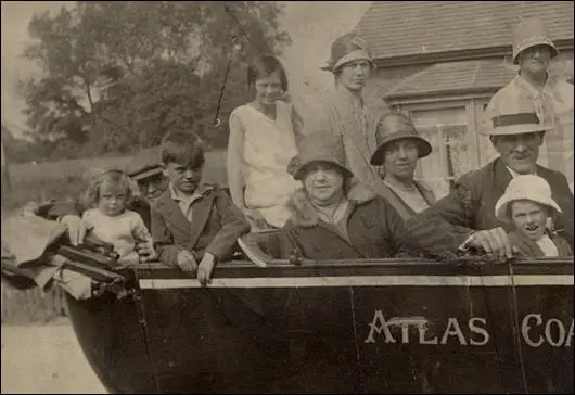 A group of holiday-makers on a charabanc outing arranged by Atlas Coaches in 1928. Muriel Hughes, then aged about fourteen, is the young girl in the white dress sitting at the rear of the charabanc with her family. my grandmother, sits propped up to the right of her daughter. My grandfather is seated right at the back of the charabanc flanked by Muriel's two siblings, Stella, aged two and her eight year old brother Jack.