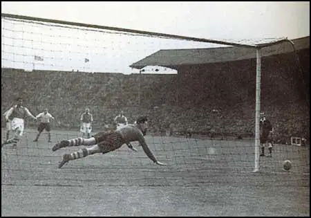 Jack Fairbrother attempts to stop a penalty kick by Leslie Compton during the1941 Football League Cup Final. The ball hit the post and bounced back into play.