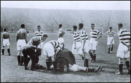 John Thomson is surrounded by anxious onlookers.