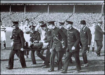 St Andrew's Ambulance Association carry Thomson from the pitch.