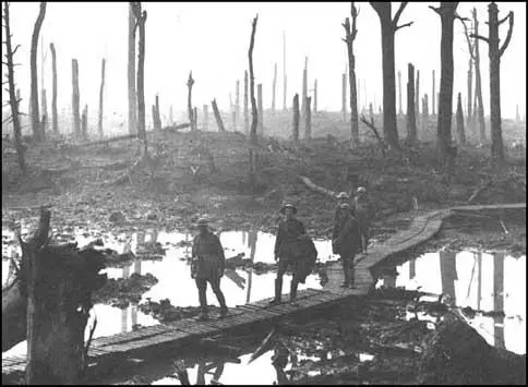 Australian soldiers walking on duck-boards at Passchendaele