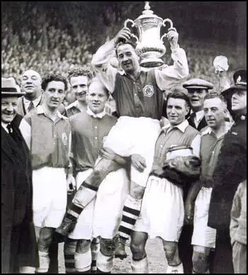 Alex James holds the FA Cup won at Wembley in 1936.
