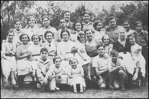 A group photograph of Basque children at Theydon Bois. Leah Manning is seated, right of middle, with a child on her right knee.