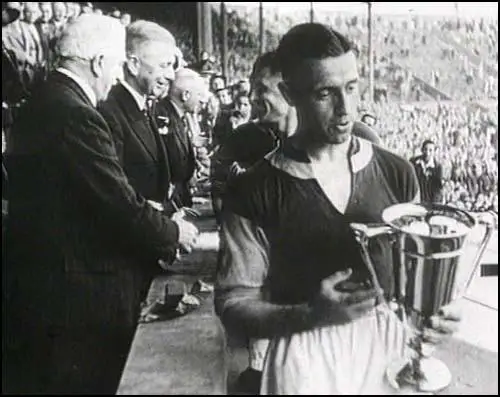 Charlie Bicknell receives the cup.